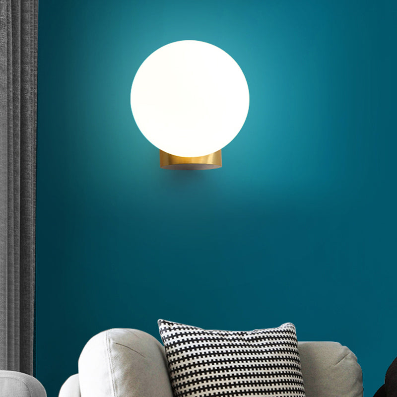 Simple Spherical Wall Mount Lamp Opal Glass 1 Bulb Bedside Wall Sconce Light in Brass Clearhalo 'Cast Iron' 'Glass' 'Industrial' 'Modern wall lights' 'Modern' 'Tiffany' 'Traditional wall lights' 'Wall Lamps & Sconces' 'Wall Lights' Lighting' 2468029
