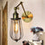 1 Light Arm Adjustable Wall Lighting with Cage Shade Loft Style Black/Brass/Aged Brass Wall Mount Light over Table Brass Clearhalo 'Art deco wall lights' 'Cast Iron' 'Glass' 'Industrial wall lights' 'Industrial' 'Middle century wall lights' 'Modern' 'Rustic wall lights' 'Tiffany' 'Traditional wall lights' 'Wall Lamps & Sconces' 'Wall Lights' Lighting' 248343