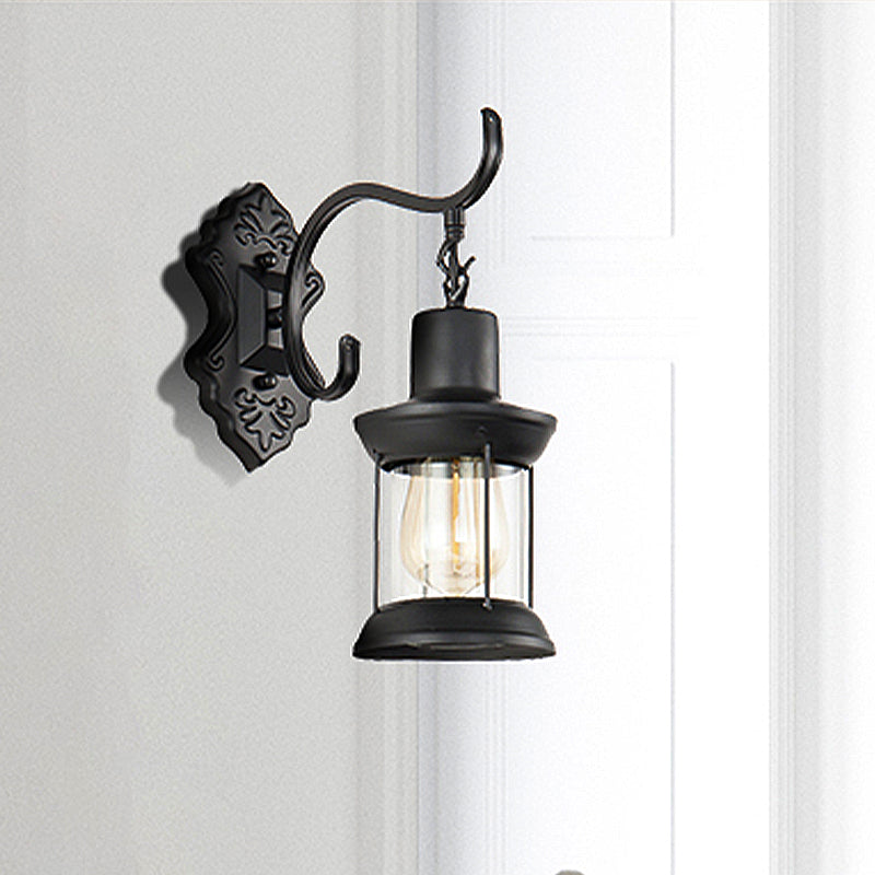 Lantern Clear Glass Wall Mounted Lamp Vintage Single Bulb Outdoor Sconce Light in Black with Carved Pattern Clearhalo 'Art deco wall lights' 'Cast Iron' 'Glass' 'Industrial wall lights' 'Industrial' 'Middle century wall lights' 'Modern' 'Rustic wall lights' 'Tiffany' 'Traditional wall lights' 'Wall Lamps & Sconces' 'Wall Lights' Lighting' 250640