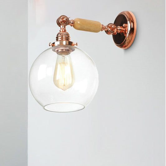 Orb Shade Clear Glass Wall Mounted Lamp Industrial Single Bulb Living Room Sconce Light in Rose Gold Clearhalo 'Cast Iron' 'Glass' 'Industrial wall lights' 'Industrial' 'Middle century wall lights' 'Modern' 'Tiffany' 'Traditional wall lights' 'Wall Lamps & Sconces' 'Wall Lights' Lighting' 251016