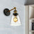 Tapered Bedroom Sconce Light Fixture Rustic Clear Glass 1 Light Black Wall Lamp with Plug-in Cord Clear Clearhalo 'Cast Iron' 'Glass' 'Industrial wall lights' 'Industrial' 'Middle century wall lights' 'Modern' 'Tiffany' 'Traditional wall lights' 'Wall Lamps & Sconces' 'Wall Lights' Lighting' 253565