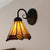 Rustic Conical Wall Mount Light with Curved Arm 1 Light Stained Glass Bedroom Wall Sconce Beige Clearhalo 'Industrial' 'Middle century wall lights' 'Tiffany wall lights' 'Tiffany' 'Wall Lamps & Sconces' 'Wall Lights' Lighting' 253646