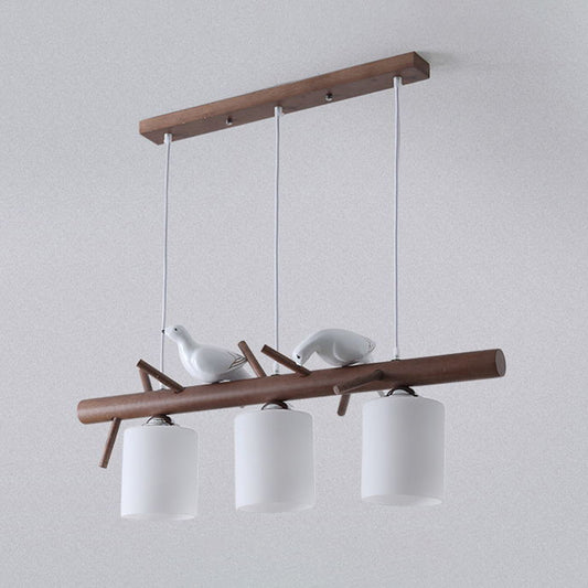 3 Lights Nutcracker Wood Island Pendant Lighting Contemporary Cylindrical Glass Shade Island Lamps Brown Clearhalo 'Ceiling Lights' 'Island Lights' Lighting' 2557065