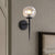 Black/Gold Round Wall Lighting Modern Clear Glass 1 Light Bedroom Sconce Light Fixture Black Clearhalo 'Cast Iron' 'Glass' 'Industrial wall lights' 'Industrial' 'Middle century wall lights' 'Modern' 'Tiffany' 'Traditional wall lights' 'Wall Lamps & Sconces' 'Wall Lights' Lighting' 256081