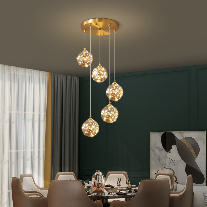Brass Finish Globe Suspension Lamp Nordic Amber Glass LED Starry Pendant Lighting for Bedroom Clearhalo 'Ceiling Lights' 'Glass shade' 'Glass' 'Modern Pendants' 'Modern' 'Pendant Lights' 'Pendants' Lighting' 2593465