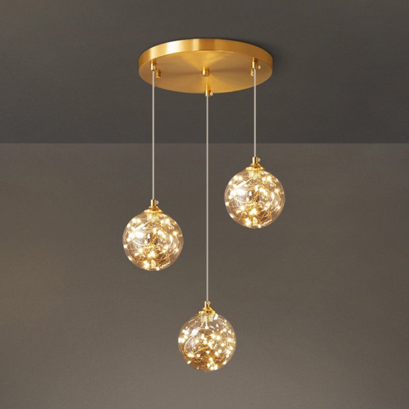 Brass Finish Globe Suspension Lamp Nordic Amber Glass LED Starry Pendant Lighting for Bedroom Clearhalo 'Ceiling Lights' 'Glass shade' 'Glass' 'Modern Pendants' 'Modern' 'Pendant Lights' 'Pendants' Lighting' 2593470