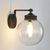 Industrial Global Sconce Light Glass and Metal 1 Bulb Wall Light Fixture in Matte Black Finish Matte Black Clearhalo 'Cast Iron' 'Glass' 'Industrial wall lights' 'Industrial' 'Middle century wall lights' 'Modern' 'Tiffany' 'Traditional wall lights' 'Wall Lamps & Sconces' 'Wall Lights' Lighting' 259591