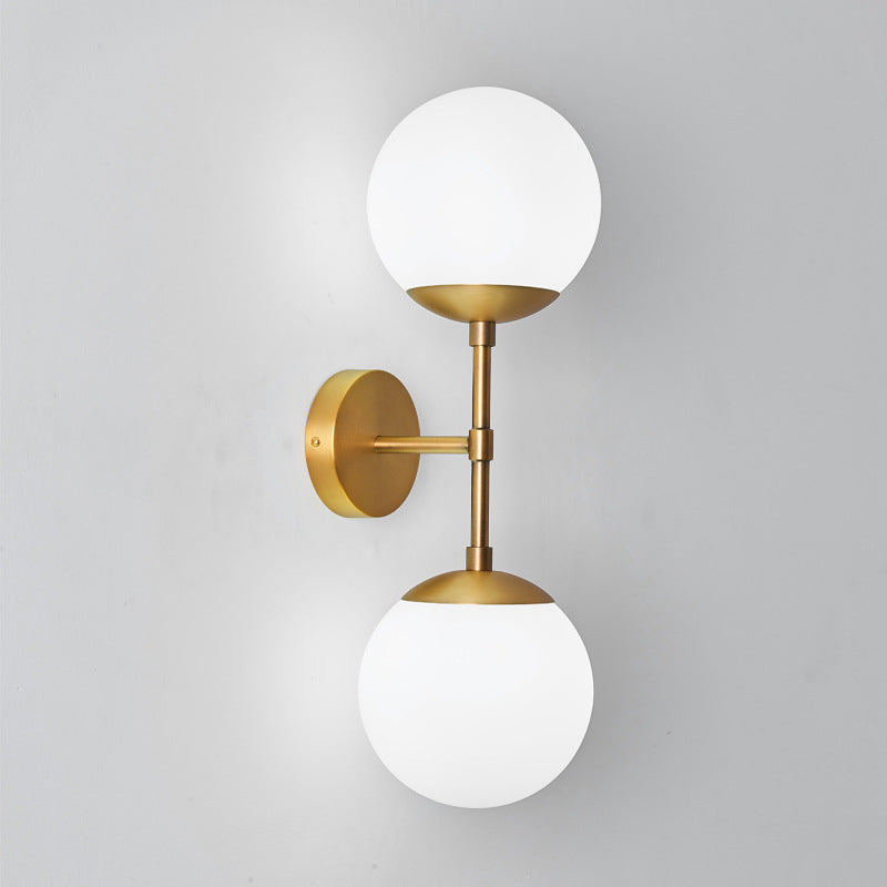 Armed Double Globe Wall Sconce Light Minimalist Milky Glass 2-Light Wall Mount Lamp in Brass Clearhalo 'Cast Iron' 'Glass' 'Industrial' 'Modern wall lights' 'Modern' 'Tiffany' 'Traditional wall lights' 'Wall Lamps & Sconces' 'Wall Lights' Lighting' 269655