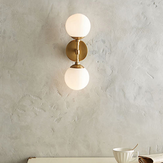 Armed Double Globe Wall Sconce Light Minimalist Milky Glass 2-Light Wall Mount Lamp in Brass Clearhalo 'Cast Iron' 'Glass' 'Industrial' 'Modern wall lights' 'Modern' 'Tiffany' 'Traditional wall lights' 'Wall Lamps & Sconces' 'Wall Lights' Lighting' 269657