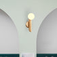 Simple Ball Shape Wall Sconce Matte White Glass 1 Light Gold Wall Mount Light Fixture Clearhalo 'Cast Iron' 'Glass' 'Industrial' 'Modern wall lights' 'Modern' 'Tiffany' 'Traditional wall lights' 'Wall Lamps & Sconces' 'Wall Lights' Lighting' 269685