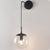 Clear/Smoke Grey Glass Sphere Wall Sconce Retro 1 Light Wall Mount Lamp with Long Gold/Black Arm Black Clearhalo 'Cast Iron' 'Glass' 'Industrial' 'Modern wall lights' 'Modern' 'Tiffany' 'Traditional wall lights' 'Wall Lamps & Sconces' 'Wall Lights' Lighting' 273162
