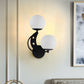 2 Bulbs Bedroom Sconce Light Contemporary Black/Gold Wall Lamp with Left/Right Milky Glass Ball Shade Clearhalo 'Cast Iron' 'Glass' 'Industrial' 'Modern wall lights' 'Modern' 'Tiffany' 'Traditional wall lights' 'Wall Lamps & Sconces' 'Wall Lights' Lighting' 274262