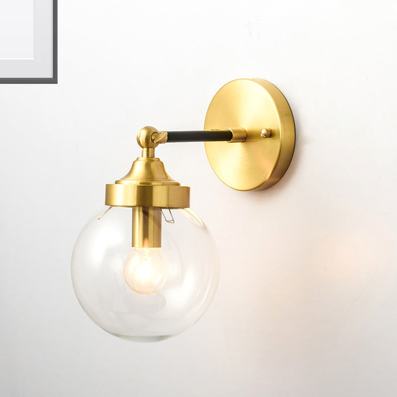 Adjustable Globe Sconce Light Simplicity 1 Bulb Brass Wall Mount Lamp with Transparent Glass Shade Clearhalo 'Cast Iron' 'Glass' 'Industrial' 'Modern wall lights' 'Modern' 'Tiffany' 'Traditional wall lights' 'Wall Lamps & Sconces' 'Wall Lights' Lighting' 275010