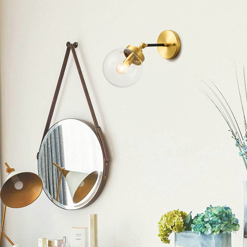 Adjustable Globe Sconce Light Simplicity 1 Bulb Brass Wall Mount Lamp with Transparent Glass Shade Clearhalo 'Cast Iron' 'Glass' 'Industrial' 'Modern wall lights' 'Modern' 'Tiffany' 'Traditional wall lights' 'Wall Lamps & Sconces' 'Wall Lights' Lighting' 275012