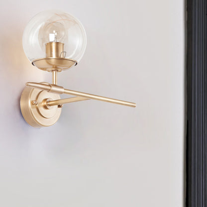 Brass Globe Wall Light Contemporary 1 Light Hand Blown Glass Sconce Light with Crossed Arm Brass Clearhalo 'Cast Iron' 'Glass' 'Industrial' 'Modern wall lights' 'Modern' 'Tiffany' 'Traditional wall lights' 'Wall Lamps & Sconces' 'Wall Lights' Lighting' 275131