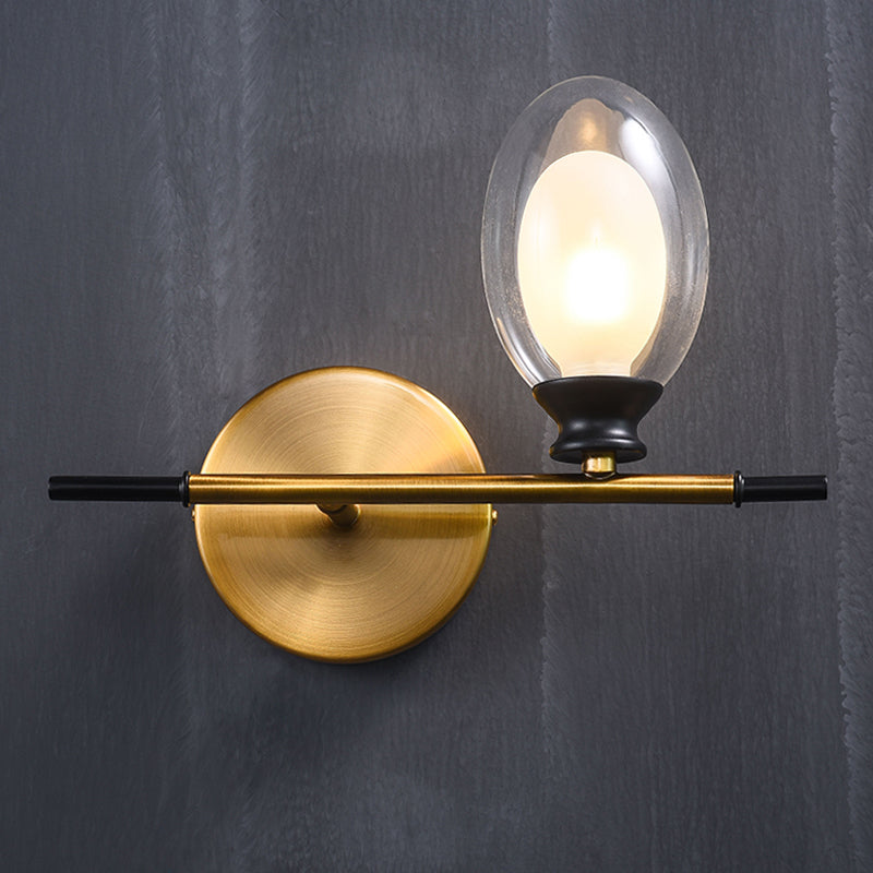 Clear/Amber Glass Egg Shape Wall Light Fixture Minimalist 1 Light Brass Sconce with Horizontal Arm Clearhalo 'Cast Iron' 'Glass' 'Industrial' 'Modern wall lights' 'Modern' 'Tiffany' 'Traditional wall lights' 'Wall Lamps & Sconces' 'Wall Lights' Lighting' 275242