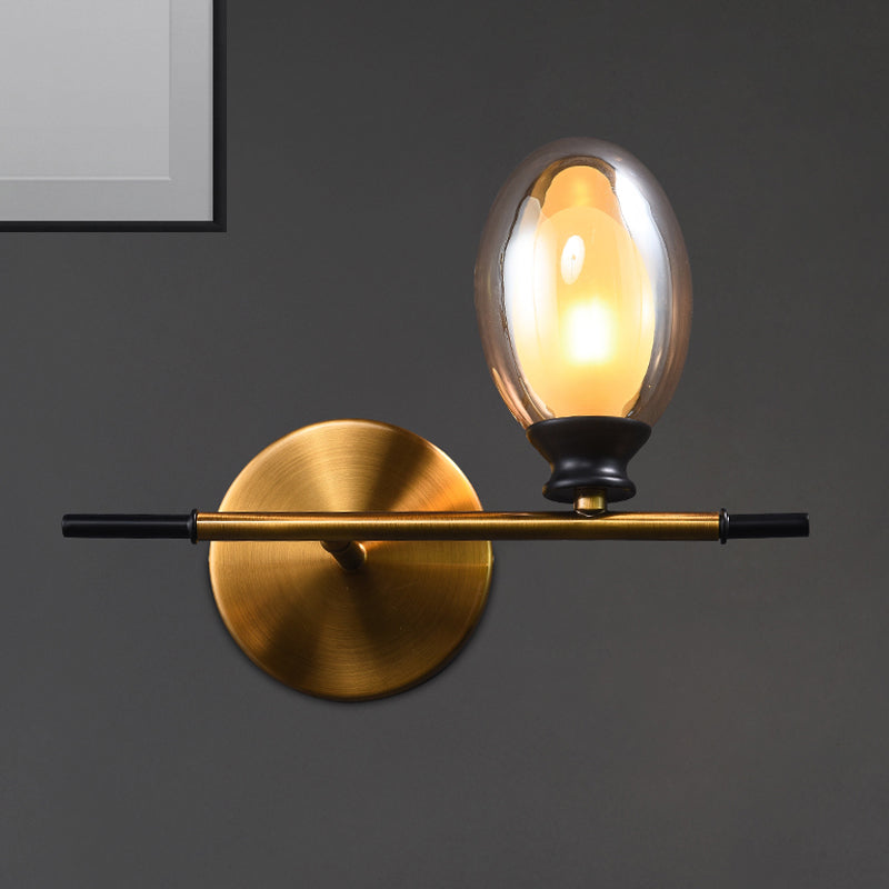 Clear/Amber Glass Egg Shape Wall Light Fixture Minimalist 1 Light Brass Sconce with Horizontal Arm - Amber - Clearhalo - 'Cast Iron' - 'Glass' - 'Industrial' - 'Modern wall lights' - 'Modern' - 'Tiffany' - 'Traditional wall lights' - 'Wall Lamps & Sconces' - 'Wall Lights' - Lighting' - 275247