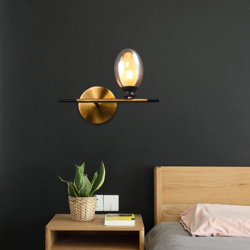 Clear/Amber Glass Egg Shape Wall Light Fixture Minimalist 1 Light Brass Sconce with Horizontal Arm - Clearhalo - 'Cast Iron' - 'Glass' - 'Industrial' - 'Modern wall lights' - 'Modern' - 'Tiffany' - 'Traditional wall lights' - 'Wall Lamps & Sconces' - 'Wall Lights' - Lighting' - 275249