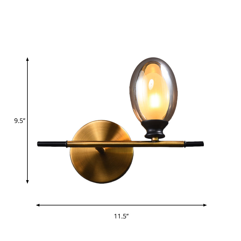 Clear/Amber Glass Egg Shape Wall Light Fixture Minimalist 1 Light Brass Sconce with Horizontal Arm Clearhalo 'Cast Iron' 'Glass' 'Industrial' 'Modern wall lights' 'Modern' 'Tiffany' 'Traditional wall lights' 'Wall Lamps & Sconces' 'Wall Lights' Lighting' 275251