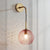 Pink/Yellow/Blue Glass Globe Wall Mounted Lamp Retro 1 Bulb Armed Sconce Light in Brass Finish Pink Clearhalo 'Cast Iron' 'Glass' 'Industrial' 'Modern wall lights' 'Modern' 'Tiffany' 'Traditional wall lights' 'Wall Lamps & Sconces' 'Wall Lights' Lighting' 275411