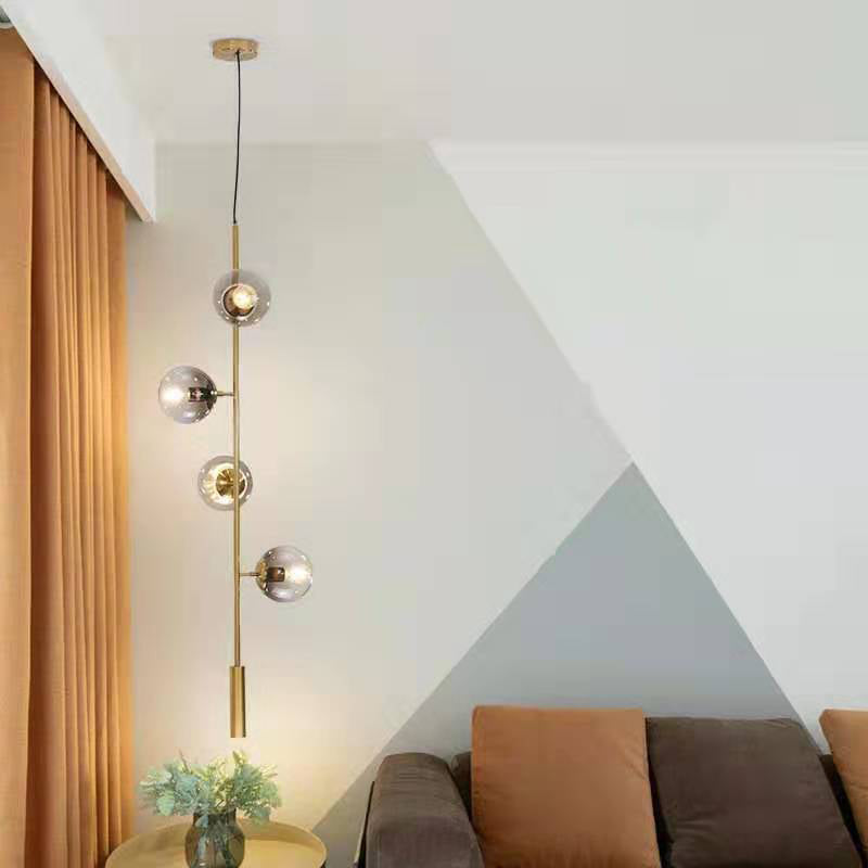 Modernist Globe Pendant Lighting Grey Glass 4 Bulbs Living Room Ceiling Chandelier in Gold with Pencil Arm Clearhalo 'Ceiling Lights' 'Chandeliers' 'Glass shade' 'Glass' 'Modern Chandeliers' 'Modern' 'Pendant Lights' Lighting' 303474