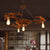 4 Lights Metal Pendant Lighting Vintage Antique Bronze Open Bulb Dining Room Ceiling Chandelier with Gear Deco Antique Bronze Clearhalo 'Cast Iron' 'Ceiling Lights' 'Chandeliers' 'Industrial Chandeliers' 'Industrial' 'Metal' 'Middle Century Chandeliers' 'Rustic Chandeliers' 'Tiffany' Lighting' 314478