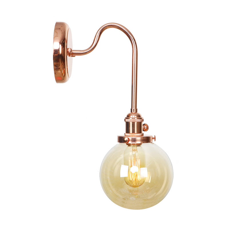 Vintage Globe Wall Lighting 1 Light Clear/Amber Glass Sconce in Copper with Curved Arm Clearhalo 'Art deco wall lights' 'Cast Iron' 'Glass' 'Industrial wall lights' 'Industrial' 'Middle century wall lights' 'Modern' 'Rustic wall lights' 'Tiffany' 'Traditional wall lights' 'Wall Lamps & Sconces' 'Wall Lights' Lighting' 315401