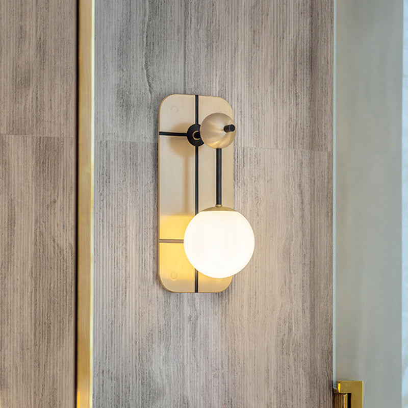 Opal Glass Ball Sconce Modernist 1 Head Brass Wall Mounted Light Fixture with Metal Rectangle Backplate Clearhalo 'Cast Iron' 'Glass' 'Industrial' 'Modern wall lights' 'Modern' 'Tiffany' 'Traditional wall lights' 'Wall Lamps & Sconces' 'Wall Lights' Lighting' 324117