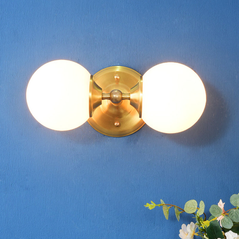 Spherical Sconce Contemporary Milky Glass 2 Heads Wall Mount Light Fixture in Brass Brass Clearhalo 'Cast Iron' 'Glass' 'Industrial' 'Modern wall lights' 'Modern' 'Tiffany' 'Traditional wall lights' 'Wall Lamps & Sconces' 'Wall Lights' Lighting' 324225