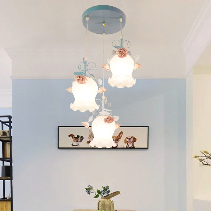 White Glass Rose Multi Light Pendant Pastoral 3 Bulbs Dining Room Suspension Lighting Fixture in Blue Clearhalo 'Ceiling Lights' 'Glass shade' 'Glass' 'Pendant Lights' 'Pendants' Lighting' 325588