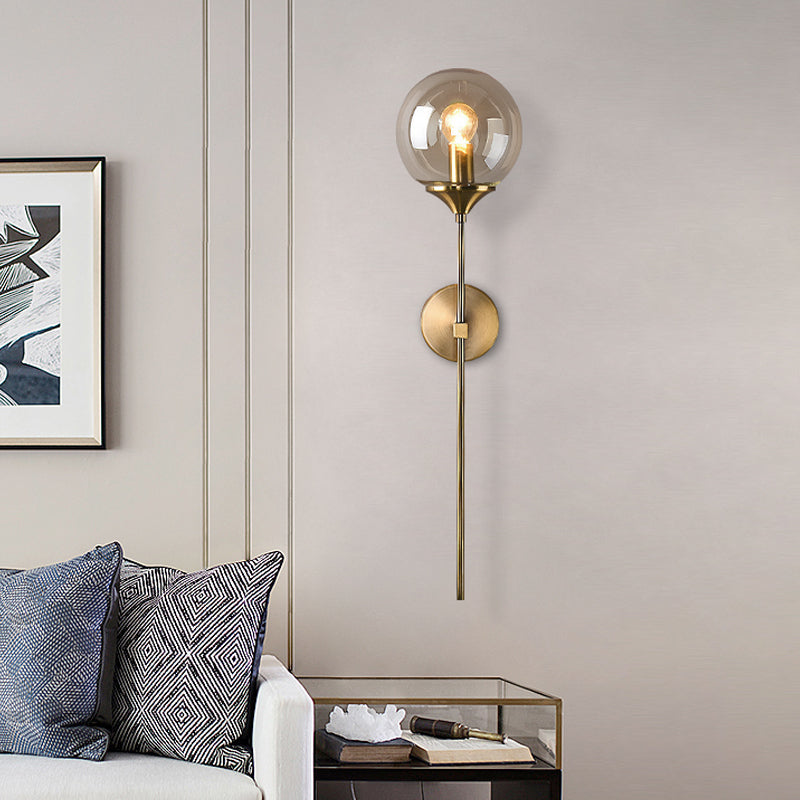 Modernist Round Wall Lamp Clear/Amber/Smoke Gray Glass 1 Bulb Bedside Sconce Light Fixture with Metal Pencil Arm - Clearhalo - 'Cast Iron' - 'Glass' - 'Industrial' - 'Modern wall lights' - 'Modern' - 'Tiffany' - 'Traditional wall lights' - 'Wall Lamps & Sconces' - 'Wall Lights' - Lighting' - 325674