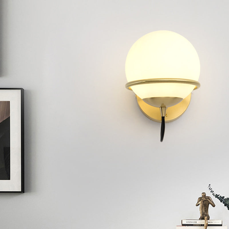 1 Head Bedside Sconce Light Modern Brass Wall Lighting Fixture with Global White Glass Shade Clearhalo 'Cast Iron' 'Glass' 'Industrial' 'Modern wall lights' 'Modern' 'Tiffany' 'Traditional wall lights' 'Wall Lamps & Sconces' 'Wall Lights' Lighting' 325976