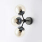 3 Bulbs Spherical Vanity Light Modern Clear Glass Wall Mounted Lighting in Black for Bathroom Clearhalo 'Cast Iron' 'Glass' 'Industrial' 'Modern wall lights' 'Modern' 'Tiffany' 'Traditional wall lights' 'Wall Lamps & Sconces' 'Wall Lights' Lighting' 330881