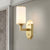 Modernism Cylindrical Sconce Light Opal Glass 1 Bulb Wall Lighting Fixture in Gold with Metal Arm Gold Clearhalo 'Cast Iron' 'Glass' 'Industrial' 'Modern wall lights' 'Modern' 'Tiffany' 'Traditional wall lights' 'Wall Lamps & Sconces' 'Wall Lights' Lighting' 331083