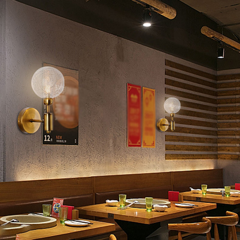 1/2-Light Bedroom Sconce Wall Light Industrial Style Black/Brass Finish Wall Lamp with Orbit Clear Glass Shade Clearhalo 'Art deco wall lights' 'Cast Iron' 'Glass' 'Industrial wall lights' 'Industrial' 'Middle century wall lights' 'Modern' 'Rustic wall lights' 'Tiffany' 'Traditional wall lights' 'Wall Lamps & Sconces' 'Wall Lights' Lighting' 331677