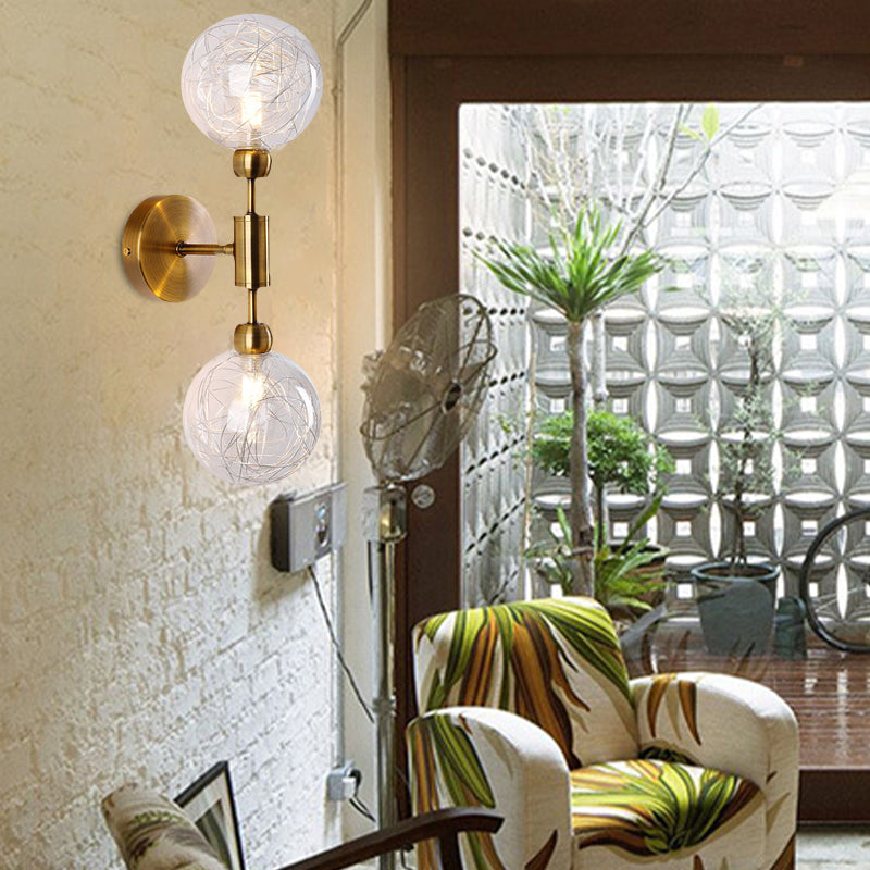 1/2-Light Bedroom Sconce Wall Light Industrial Style Black/Brass Finish Wall Lamp with Orbit Clear Glass Shade Clearhalo 'Art deco wall lights' 'Cast Iron' 'Glass' 'Industrial wall lights' 'Industrial' 'Middle century wall lights' 'Modern' 'Rustic wall lights' 'Tiffany' 'Traditional wall lights' 'Wall Lamps & Sconces' 'Wall Lights' Lighting' 331681