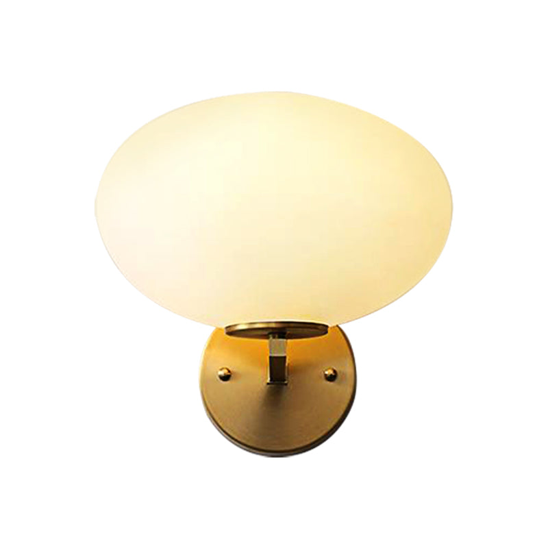 Milk Glass Oval Wall Mount Lamp Modern 1 Light Bedside Wall Sconce Light in Brass - Clearhalo - 'Cast Iron' - 'Glass' - 'Industrial' - 'Modern wall lights' - 'Modern' - 'Tiffany' - 'Traditional wall lights' - 'Vanity Lights' - 'Wall Lights' - Lighting' - 370186