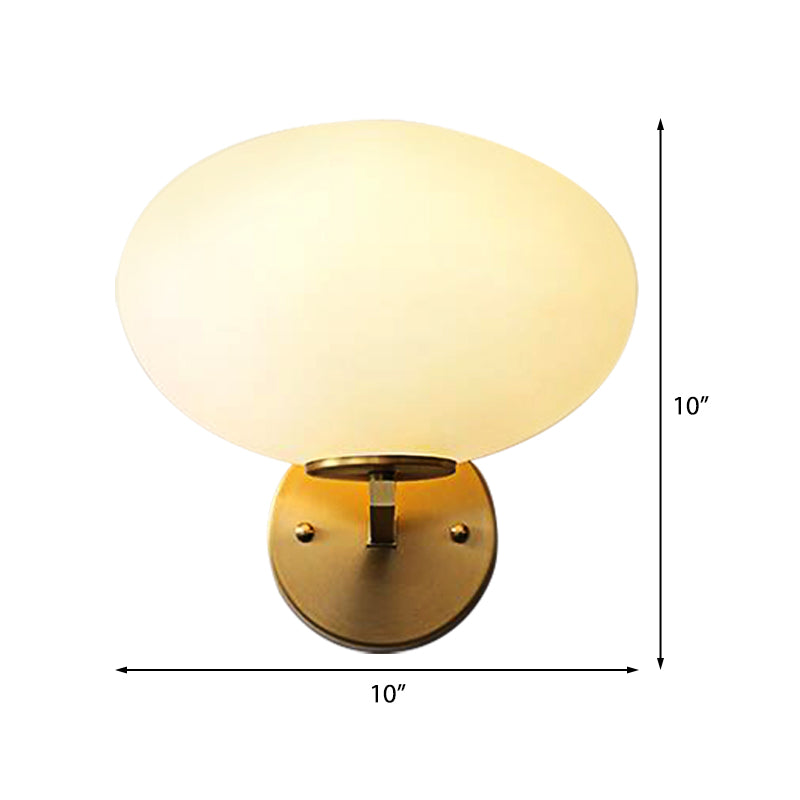 Milk Glass Oval Wall Mount Lamp Modern 1 Light Bedside Wall Sconce Light in Brass - Clearhalo - 'Cast Iron' - 'Glass' - 'Industrial' - 'Modern wall lights' - 'Modern' - 'Tiffany' - 'Traditional wall lights' - 'Vanity Lights' - 'Wall Lights' - Lighting' - 370187