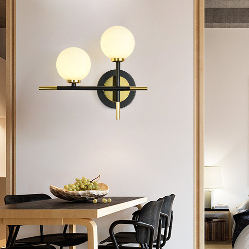 Milk Glass Orb Sconce Light with Cross Design 2 Lights Modern Black and Brass Wall Light - White - Clearhalo - 'Cast Iron' - 'Glass' - 'Industrial' - 'Modern wall lights' - 'Modern' - 'Tiffany' - 'Traditional wall lights' - 'Vanity Lights' - 'Wall Lights' - Lighting' - 370190
