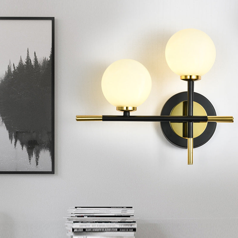 Milk Glass Orb Sconce Light with Cross Design 2 Lights Modern Black and Brass Wall Light - Clearhalo - 'Cast Iron' - 'Glass' - 'Industrial' - 'Modern wall lights' - 'Modern' - 'Tiffany' - 'Traditional wall lights' - 'Vanity Lights' - 'Wall Lights' - Lighting' - 370191