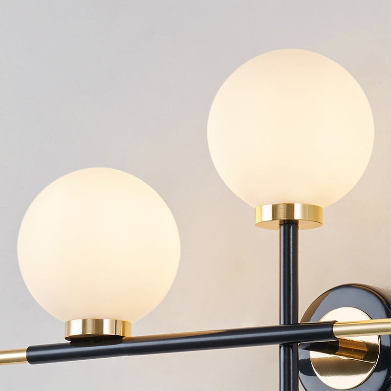 Milk Glass Orb Sconce Light with Cross Design 2 Lights Modern Black and Brass Wall Light Clearhalo 'Cast Iron' 'Glass' 'Industrial' 'Modern wall lights' 'Modern' 'Tiffany' 'Traditional wall lights' 'Vanity Lights' 'Wall Lights' Lighting' 370194