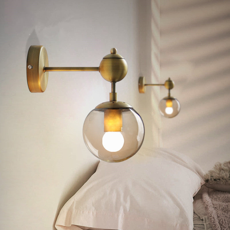 1/2-Head Global Wall Mount Light with Amber Glass Shade Modernist Wall Sconce Lighting in Gold for Bedroom 1.0 Gold Clearhalo 'Cast Iron' 'Glass' 'Industrial' 'Modern wall lights' 'Modern' 'Tiffany' 'Traditional wall lights' 'Vanity Lights' 'Wall Lights' Lighting' 370201