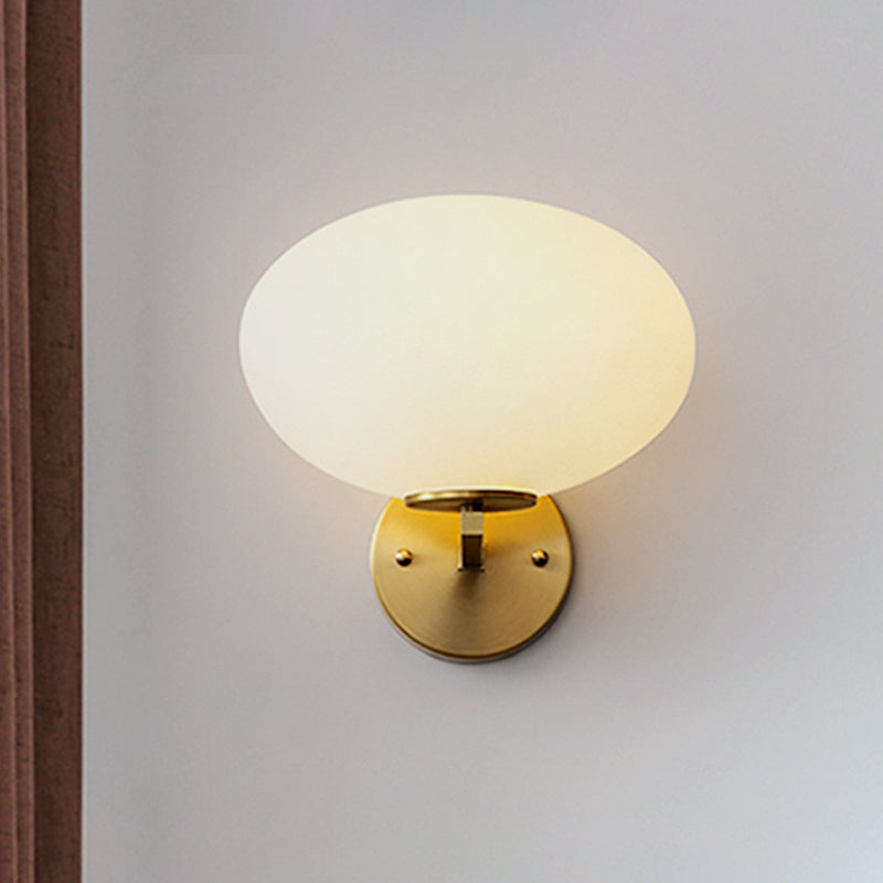 Milk Glass Oval Wall Mount Lamp Modern 1 Light Bedside Wall Sconce Light in Brass Clearhalo 'Cast Iron' 'Glass' 'Industrial' 'Modern wall lights' 'Modern' 'Tiffany' 'Traditional wall lights' 'Vanity Lights' 'Wall Lights' Lighting' 438825