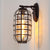 Caged Seedy Glass Wall Mounted Lamp Industrial Single Bulb Outdoor Sconce Light in Black/Bronze, 5.5"/6"/8" Wide Bronze Clearhalo 'Art deco wall lights' 'Cast Iron' 'Glass' 'Industrial wall lights' 'Industrial' 'Middle century wall lights' 'Modern' 'Rustic wall lights' 'Tiffany' 'Traditional wall lights' 'Wall Lamps & Sconces' 'Wall Lights' Lighting' 460798