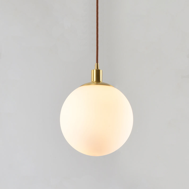 Frosted White Glass Ball Pendant Lighting Simple 1-Light 6"/8"/10" Wide Brass Suspension Ceiling Lamp Clearhalo 'Ceiling Lights' 'Glass shade' 'Glass' 'Modern Pendants' 'Modern' 'Pendant Lights' 'Pendants' Lighting' 519959