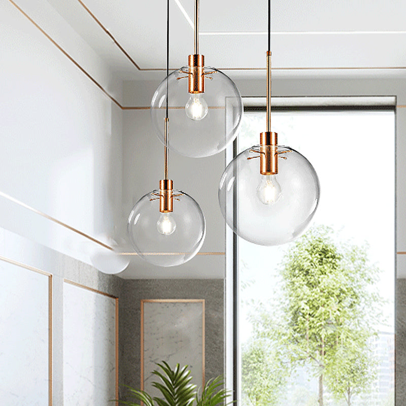 Rose Gold Round Cluster Pendant Light Minimalist 3-Bulb Clear Glass Ceiling Hang Fixture Rose Gold Clearhalo 'Ceiling Lights' 'Glass shade' 'Glass' 'Modern Pendants' 'Modern' 'Pendant Lights' 'Pendants' Lighting' 520176