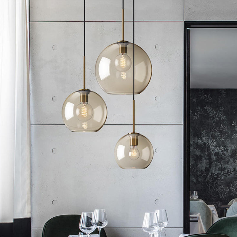 Simple 3 Lights Suspension Lighting with Amber Glass Shade Black Round Multi Lamp Pendant Black Clearhalo 'Ceiling Lights' 'Chandeliers' 'Glass shade' 'Glass' 'Modern Pendants' 'Modern' 'Pendant Lights' 'Pendants' Lighting' 520192