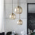 Simple 3 Lights Suspension Lighting with Amber Glass Shade Black Round Multi Lamp Pendant Black Clearhalo 'Ceiling Lights' 'Chandeliers' 'Glass shade' 'Glass' 'Modern Pendants' 'Modern' 'Pendant Lights' 'Pendants' Lighting' 520192