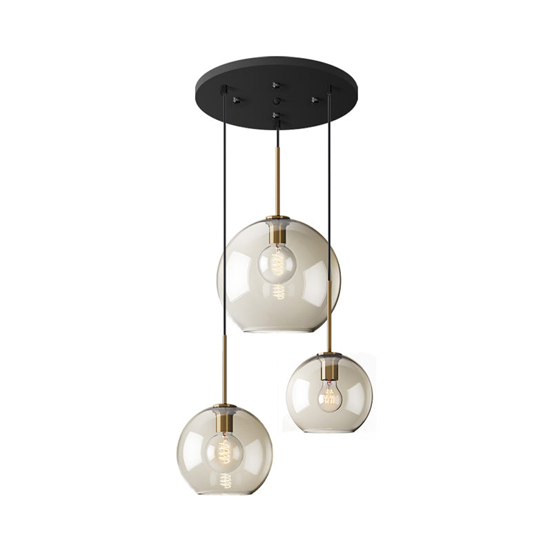Simple 3 Lights Suspension Lighting with Amber Glass Shade Black Round Multi Lamp Pendant Clearhalo 'Ceiling Lights' 'Chandeliers' 'Glass shade' 'Glass' 'Modern Pendants' 'Modern' 'Pendant Lights' 'Pendants' Lighting' 520194
