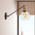 Clear Glass Globe Wall Lighting Farmhouse 1 Light Living Room Light Fixture in Black/Brass/Bronze with Arm, 8"/12" L Brass Clearhalo 'Art deco wall lights' 'Cast Iron' 'Glass' 'Industrial wall lights' 'Industrial' 'Middle century wall lights' 'Modern' 'Rustic wall lights' 'Tiffany' 'Traditional wall lights' 'Wall Lamps & Sconces' 'Wall Lights' Lighting' 520262